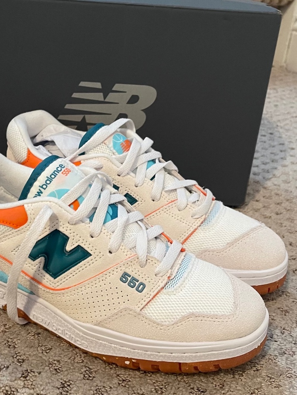 New Balance 550 white sneakers with orange and teal accents, size women’s US 10